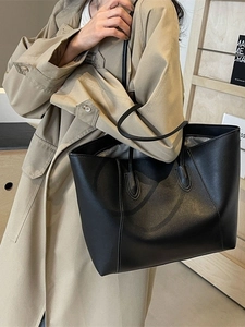 Minimalist black leather tote bag with dual handles for daily commute and stylish office wear