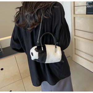 Detail of panda plush bag featuring soft faux fur texture and elegant metal chain strap