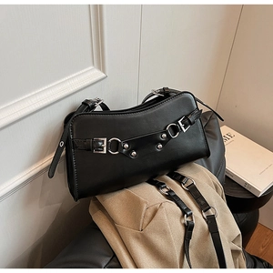 Detail view of black PU leather baguette bag featuring silver buckles and punk rivets