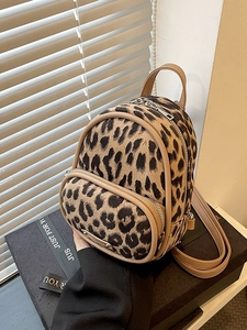 Mini leopard print backpack with brown faux leather straps and silver metal zippers