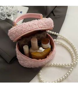 Vue détaillée du sac seau en tweed rose montrant l'intérieur et la sangle en perles