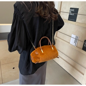 Detail of furry capybara plush cylinder bag featuring soft texture and gold chain strap