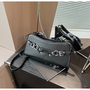 Detail of black leather bag with silver buckles and punk style metal studs decoration