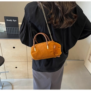 Detail view of the brown plush capybara crossbody bag with golden chain strap