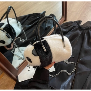 Detailed close-up of fluffy panda bag showing soft faux fur and silver chain strap
