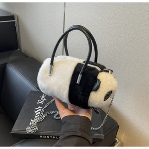 Detail of cute panda plush handbag featuring soft faux fur and metallic chain strap