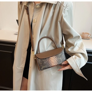 Detail of retro crocodile texture crossbody bag with adjustable strap and top handle