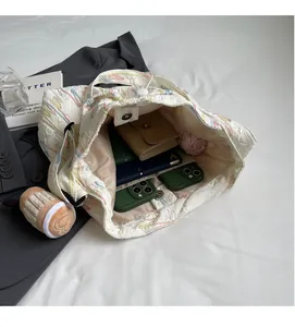 Interior view of white quilted tote bag showing large capacity for wallet and umbrella