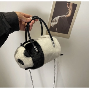 Detail of panda plush handbag with faux fur texture, leather handle and silver chain