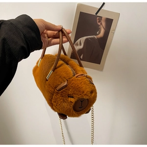 Close-up of plush capybara bag with golden chain strap and soft faux fur texture