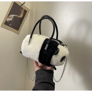 Detail of panda faux fur handbag with dual handles and detachable metal chain strap