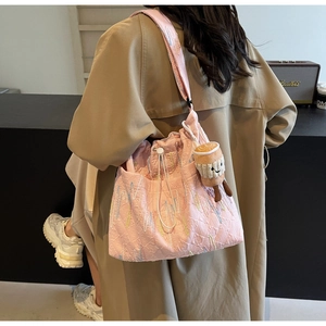 Pink quilted tote bag featuring lightning embroidery and a coffee cup plush charm