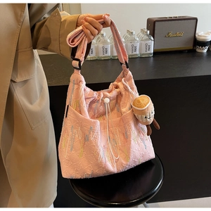 Pink tote bag detail with FF embossed fabric, drawstring closure and coffee cup plush charm
