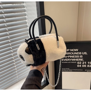 Close-up of plush panda crossbody bag featuring soft faux fur and silver chain strap