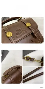 Close-up of vintage brown leather handbag featuring brass hardware and star stitching details