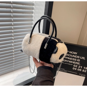 Detail of panda plush handbag featuring faux fur texture and silver metal chain strap