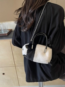 Cute panda plush chain bag with metal strap and leather handle shown in a lifestyle setting