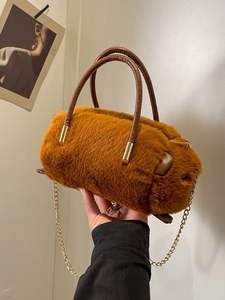 Caramel faux fur cylindrical plush handbag with leather handles and gold chain strap