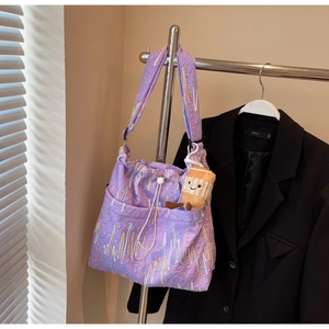 Detail of purple tote bag with textured jacquard fabric and heart-wave embroidery