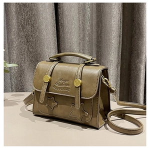 Close-up of vintage brown PU leather messenger bag with star embossing and metal buckles