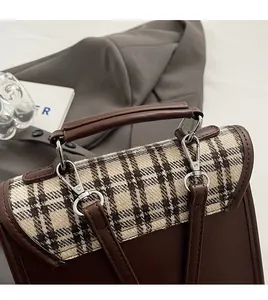 Detail of the durable top handle and plaid fabric on this vintage crossbody bag
