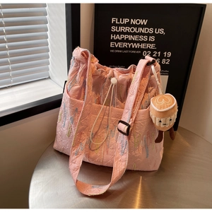 Pink drawstring bucket bag with colorful embroidery and latte coffee plush charm pendant