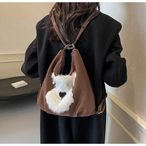 Gros plan détaillé d'un sac à dos en cuir marron avec une peluche chien sur un mannequin