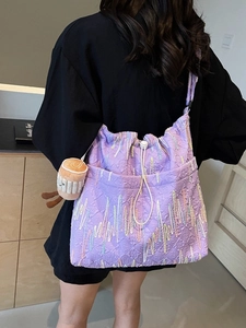 Purple jacquard tote bag with wavy embroidery and drawstring closure shown on model
