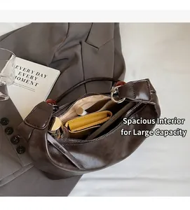 Interior view of brown leather crescent shoulder bag showing spacious storage for essentials