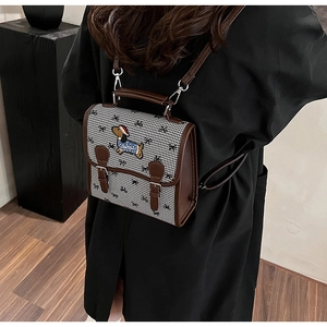 Retro houndstooth mini backpack with embroidered dachshund shown on a female model