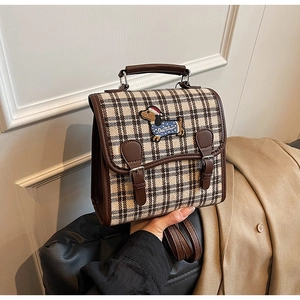 Detailed view of mini houndstooth plaid backpack featuring cute dachshund embroidery