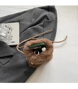 Vue détaillée de l'intérieur du sac bandoulière en fausse fourrure avec téléphone et maquillage