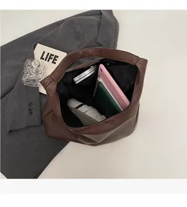 Macro shot of spacious brown PU leather bag interior with multiple storage pockets