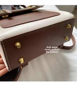 Detail view of anti-wear rivets on the leather bottom to protect the backpack base