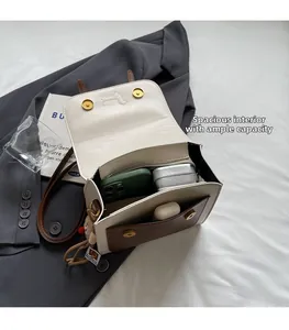 Detail view of the spacious inner compartments of a vintage beige and brown leather backpack