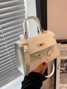 White crocodile pattern Kelly style handbag with gold hardware and shoulder strap
