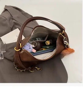 Spacious interior of brown large-capacity tote bag holding tablet, umbrella and makeup
