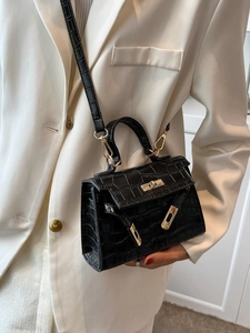 Elegant black crocodile pattern Kelly bag with gold hardware and detachable strap