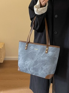 Large blue marble pattern tote bag with brown leather trim and shoulder straps for women