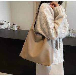 Close-up of the pebbled leather texture and spacious hobo style design of this shoulder bag