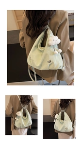 Detail of mint green hobo bag with butterfly embroidery and cloud plush charm decoration