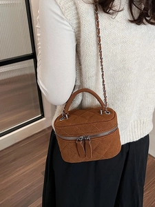 Brown quilted crossbody bucket bag with chain strap and top handle for women