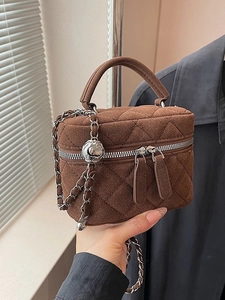 Brown quilted chain bucket bag with metal ball detail and vintage top handle strap