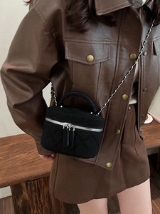 Black quilted crossbody bucket bag with chain strap and silver zippers for women