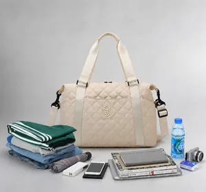 Spacious beige quilted travel bag shown with essentials to highlight large storage capacity