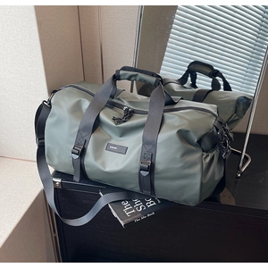 Macro detail of waterproof olive green oxford cloth duffel bag with black woven handles