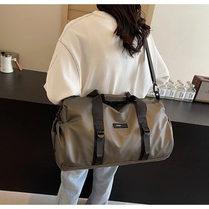 Detail of waterproof Oxford travel bag showing the side drawstring and adjustable strap