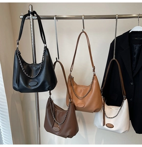 Close-up of hobo bags in four colors with textured lychee leather and silver chain