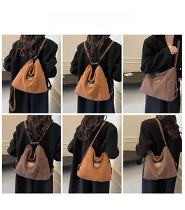 Close-up of caramel and brown tote bags with metal M logo and side pockets