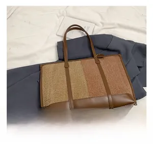 Detail showing high-capacity tote bag with brown leather base and textured tweed fabric